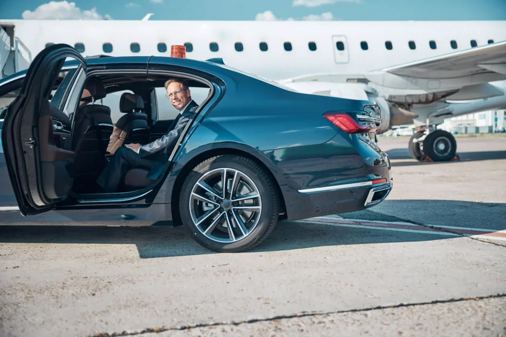 limo car in airport and plane Smiling mature businessman in car near plane