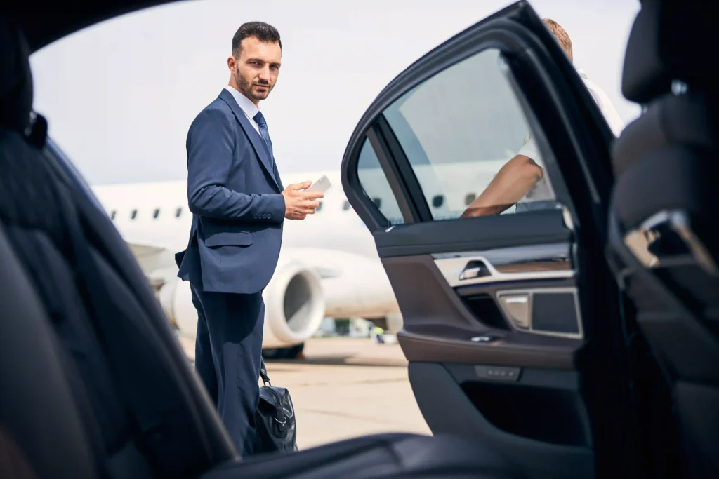 limo car in airport and plane Smiling mature businessman in car near plane