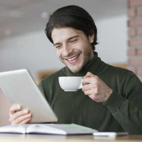 young-successful-businessman-checking-emails-while-having-morning-coffee-e1631573561115